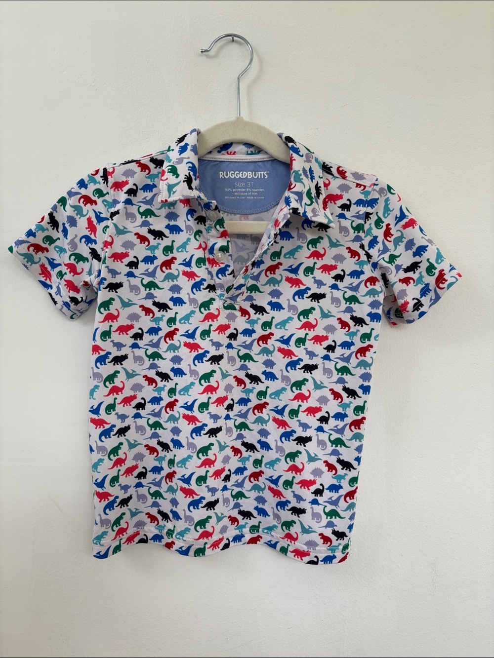 RuggedButts White Polo with Multicolor Dinosaur Print
